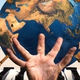 A very odd-looking hand, a weird globe, and some musical instruments, sort of.